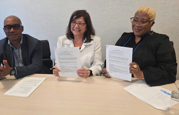 TRAC and UT-PRON sign the Memorandum of Collaboration. Left to right: Professor Innocent Barikor, Carol Hochu, and Dr. Uche Ibeh.